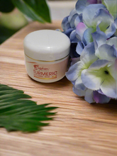 Turmeric Ascorbic Acid Cream jar beside flowers and leaves on a wooden surface, showcasing brightening and hydrating skincare.