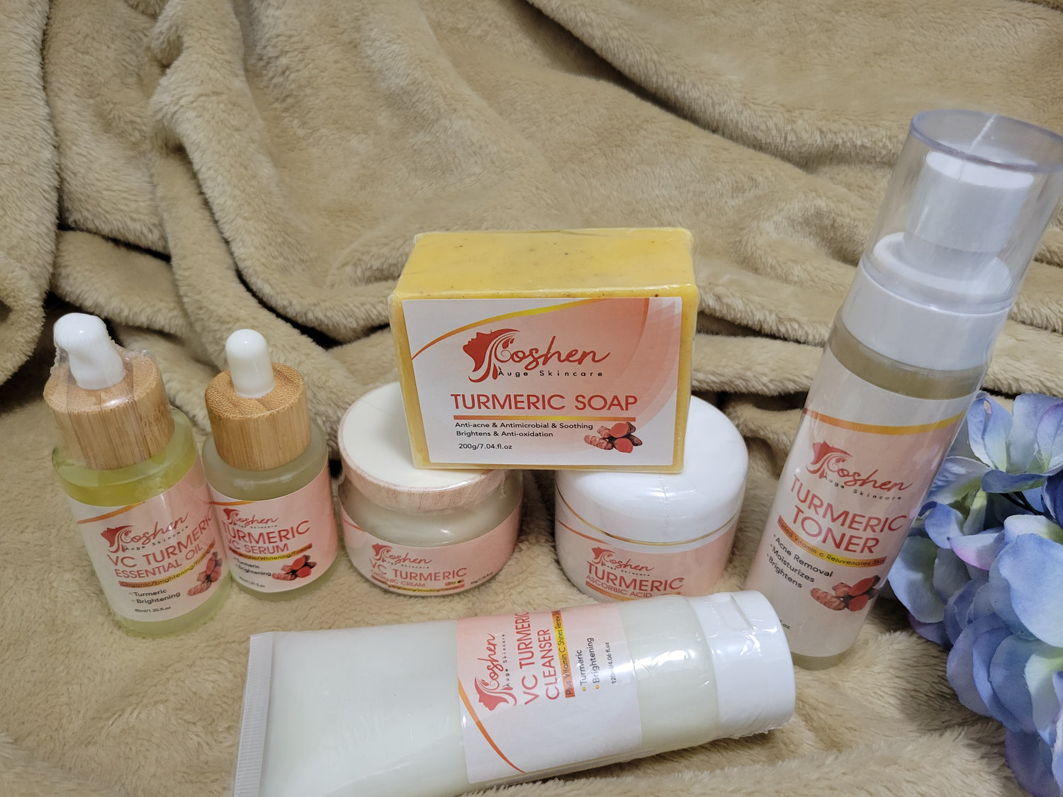 Turmeric Skincare Set with turmeric soap, serums, cleansers, and toners on a soft background.
