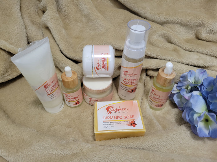 Turmeric Skincare Set featuring turmeric soap, cleansers, creams, and toners on a soft surface.